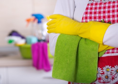 Commercial cleaner sanitising office touchpoints and surfaces